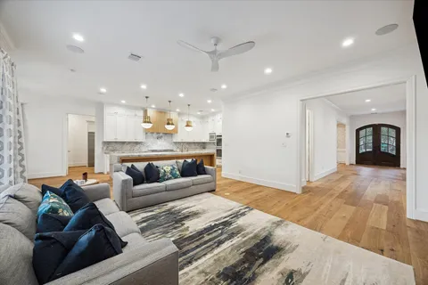 a kitchen with stainless steel appliances granite countertop a sink a stove and a wooden floors
