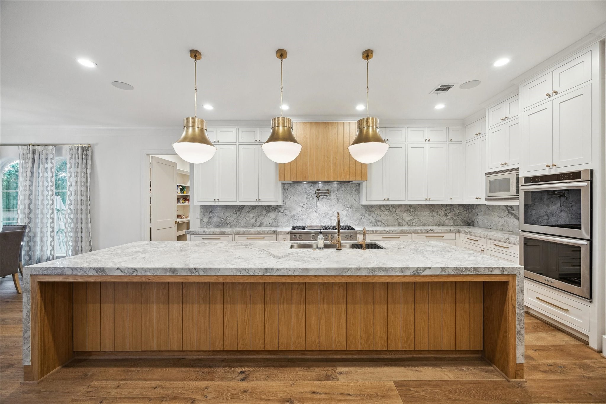 3615 Durness Way Houston, TX 77025 - Photo 14 of 46 a large kitchen with granite countertop a sink a counter top space and stainless steel appliances