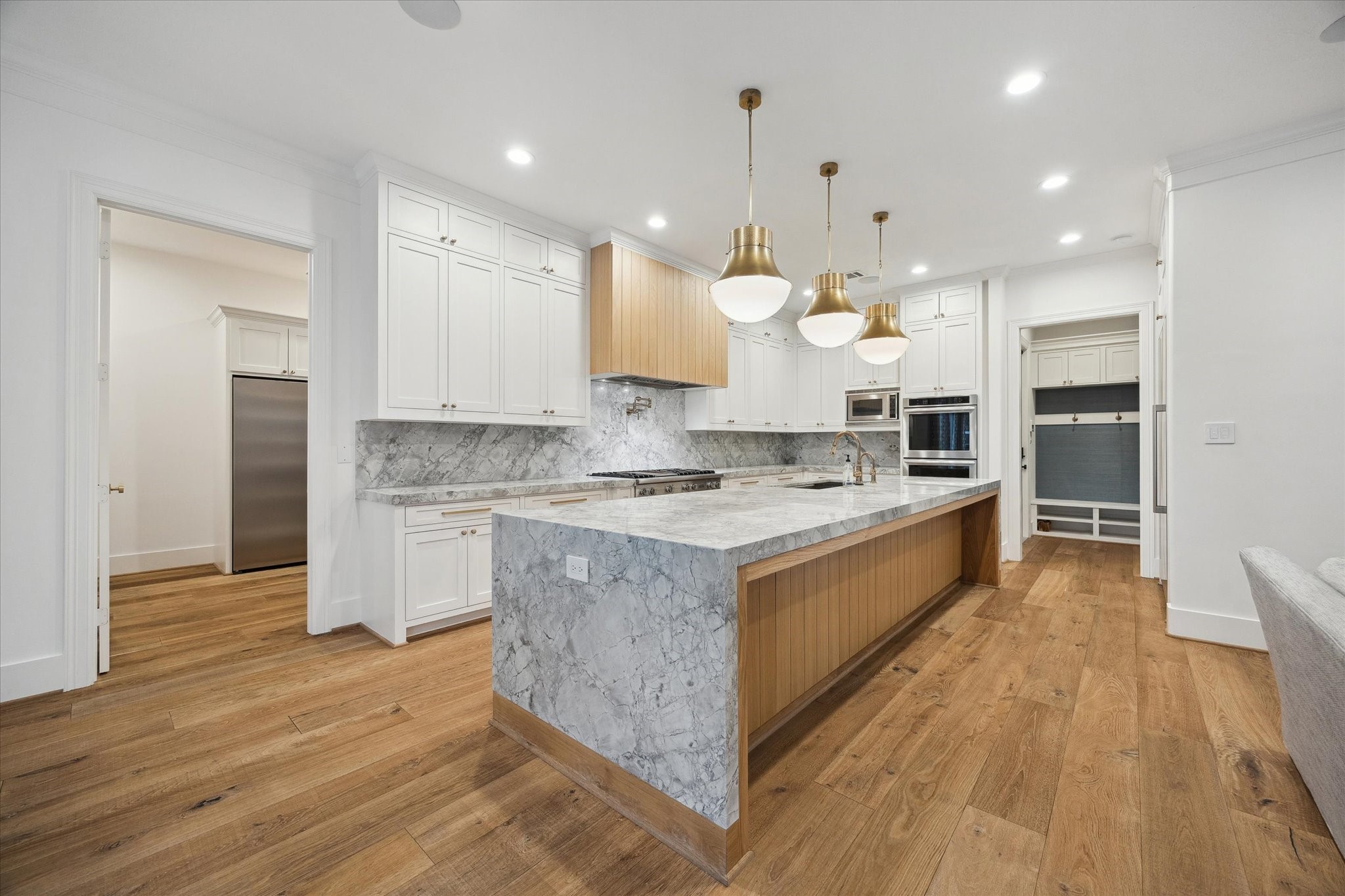 3615 Durness Way Houston, TX 77025 - Photo 17 of 46 a large kitchen with stainless steel appliances kitchen island granite countertop a large counter top and a stove