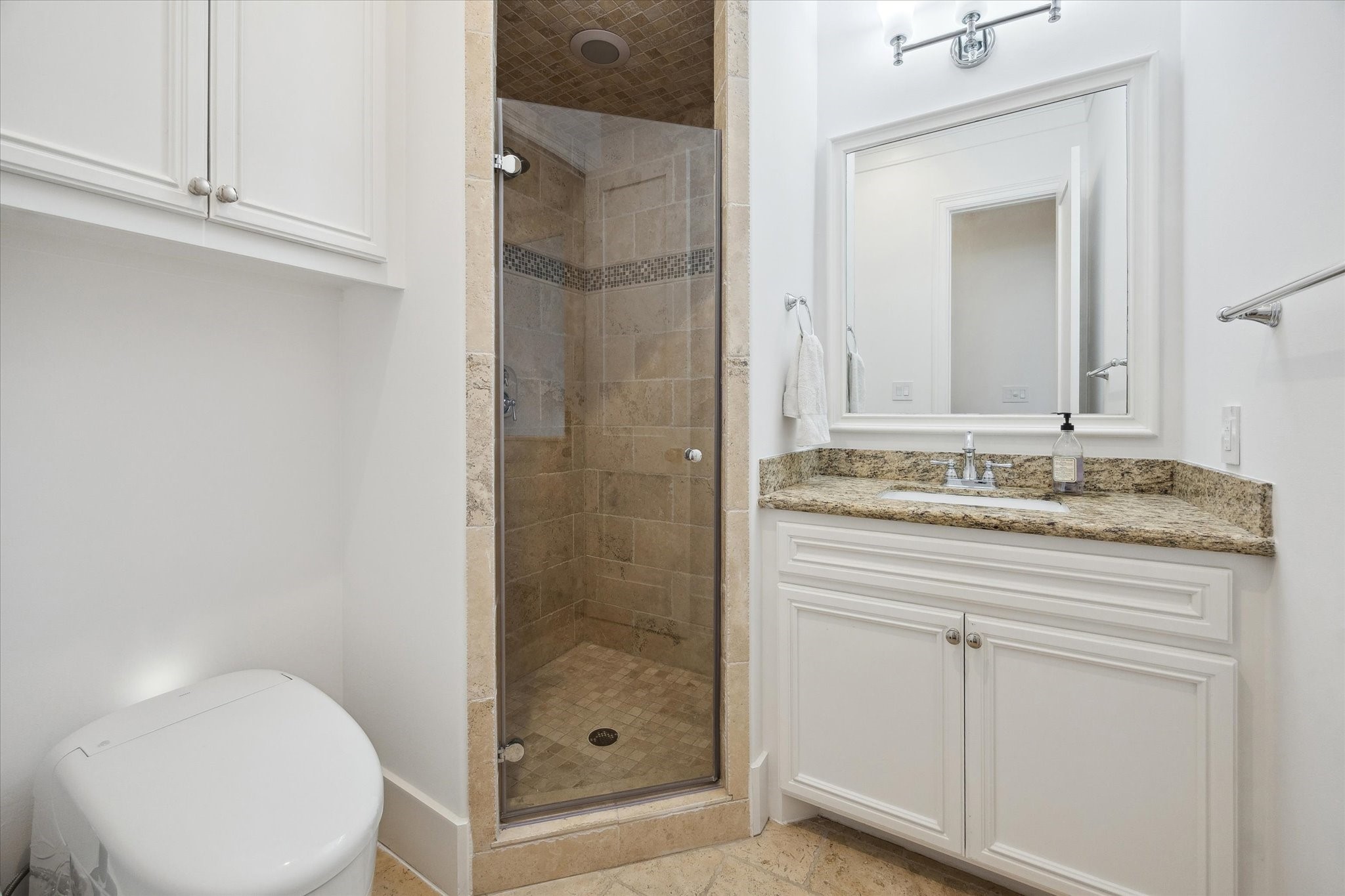 3615 Durness Way Houston, TX 77025 - Photo 24 of 46 a bathroom with a granite countertop sink a toilet and shower