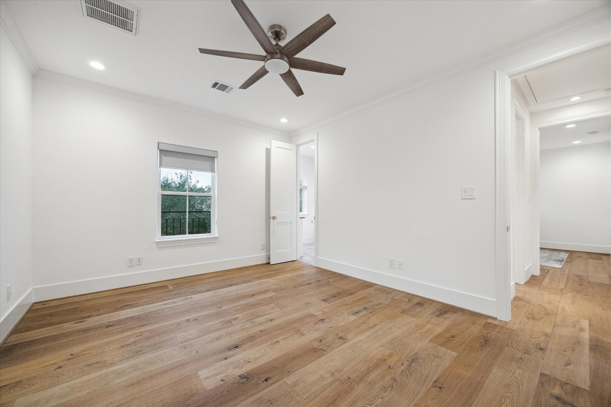 3615 Durness Way Houston, TX 77025 - Photo 28 of 46 an empty room with wooden floor and windows