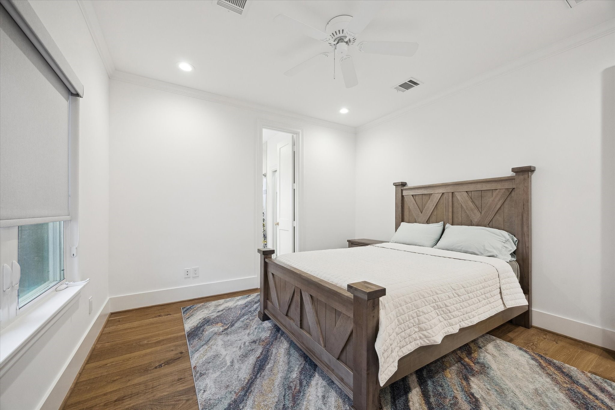 3615 Durness Way Houston, TX 77025 - Photo 31 of 46 a bedroom with a bed and wooden floor