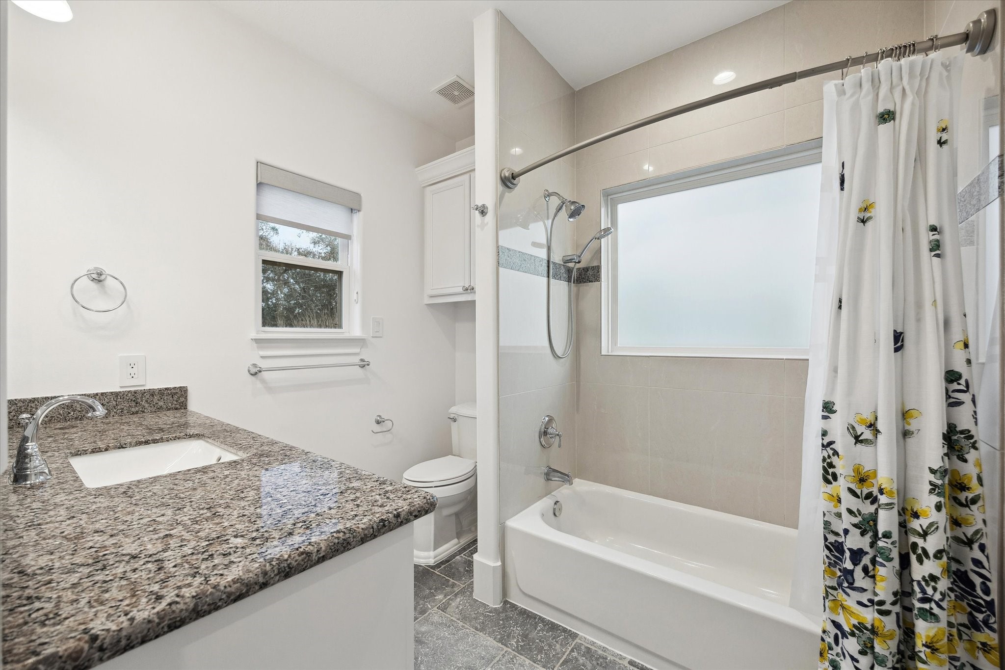 3615 Durness Way Houston, TX 77025 - Photo 32 of 46 a bathroom with a granite countertop sink a mirror a bathtub and shower