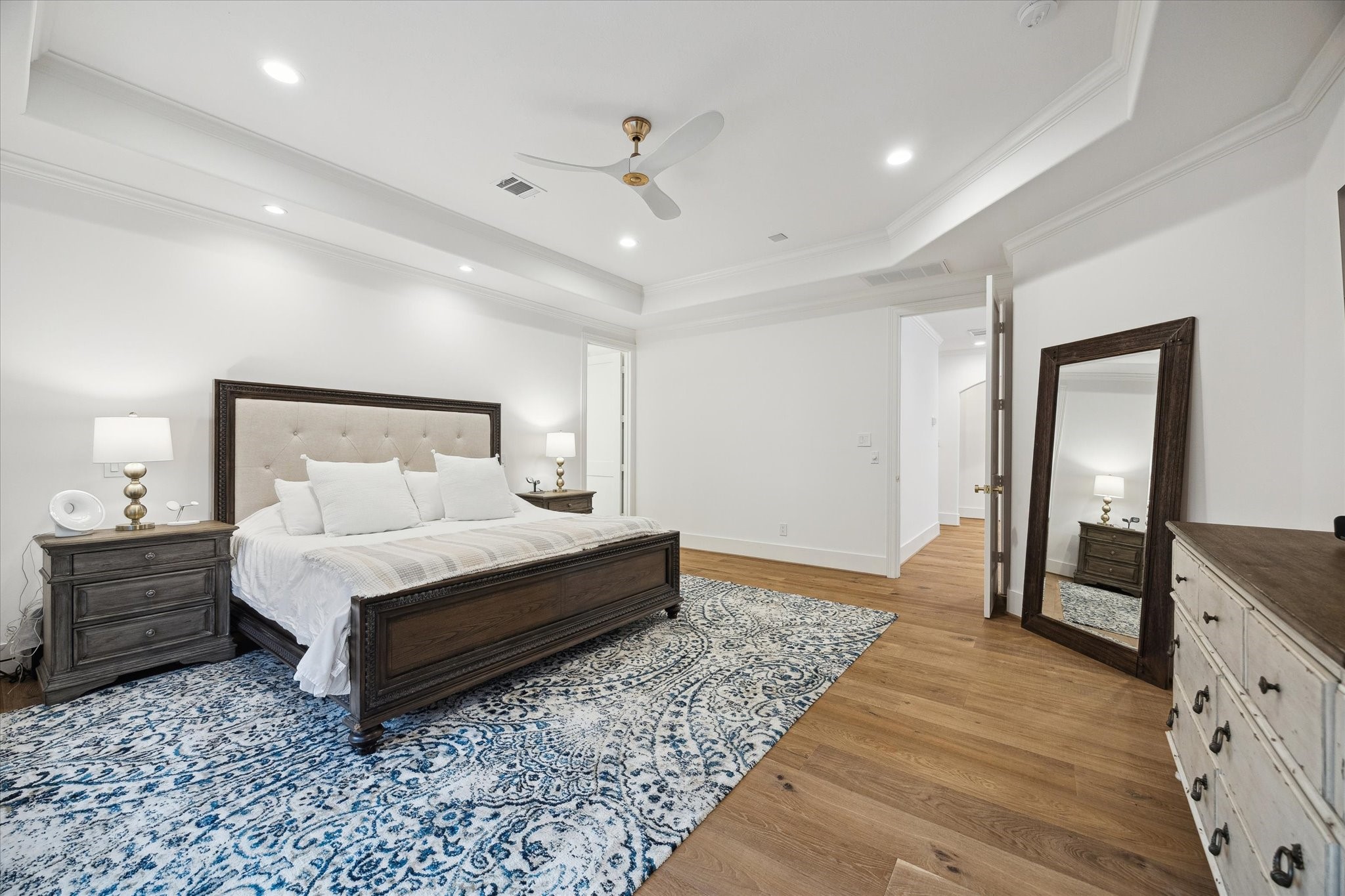 3615 Durness Way Houston, TX 77025 - Photo 35 of 46 a spacious bedroom with a bed and wooden floor