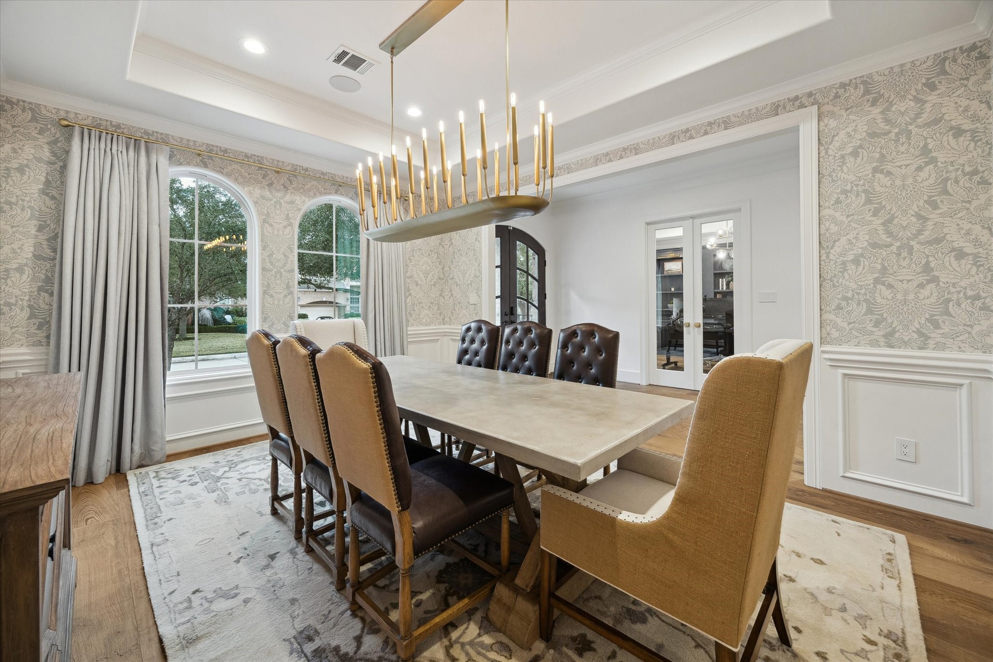3615 Durness Way Houston, TX 77025 - Photo 6 of 46 a view of a dining room with furniture a chandelier and wooden floor