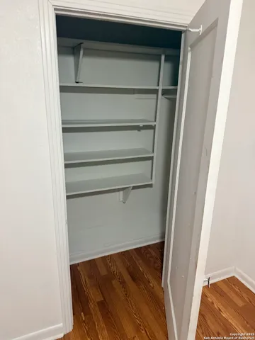 a view of walk in closet with empty racks