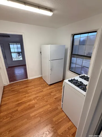 a kitchen with a stove and a refrigerator