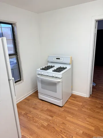 a white stove top oven sitting inside of a kitchen