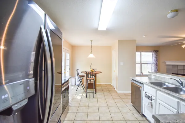 a kitchen with stainless steel appliances granite countertop a refrigerator and a stove