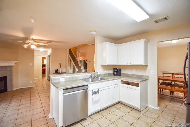 a kitchen with a stove top oven sink and cabinets
