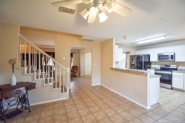 a view of a livingroom with kitchen and furniture