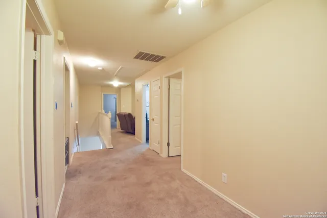 a view of a hallway with a bathroom