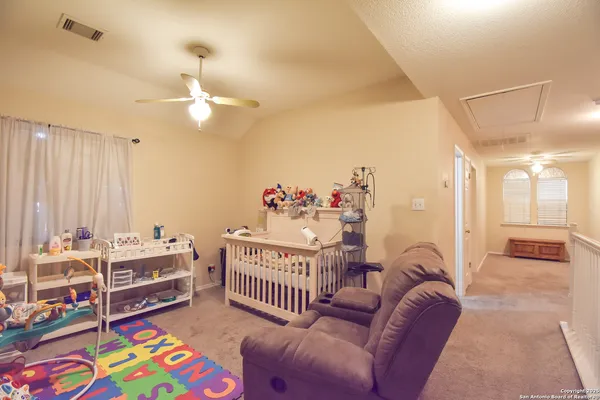 a bedroom with furniture and a chandelier