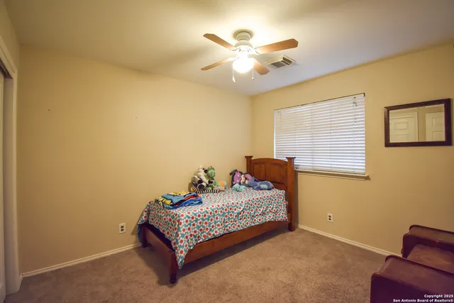 a bedroom with a bed and window