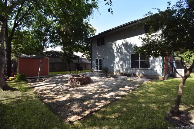 a backyard of a house with table and chairs
