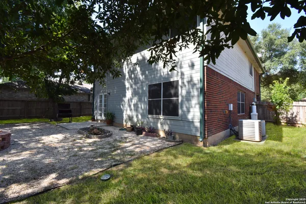 a backyard of a house with yard and outdoor seating