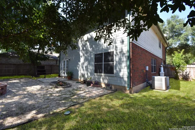 a backyard of a house with yard and outdoor seating