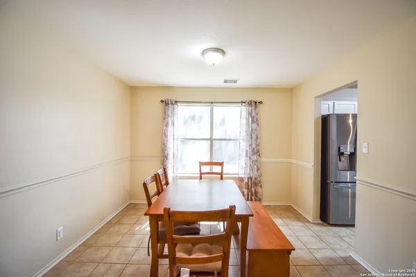 a dining room with furniture and window
