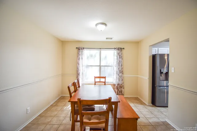a dining room with furniture and window