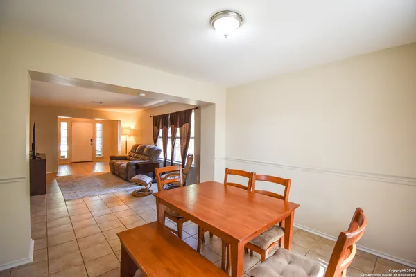 a living room with furniture a rug and a large window