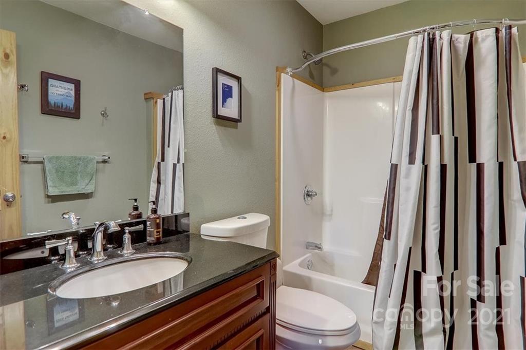 263 Summer Circle Clyde, NC 28721 - Photo 19 of 36 a bathroom with a granite countertop sink toilet and shower