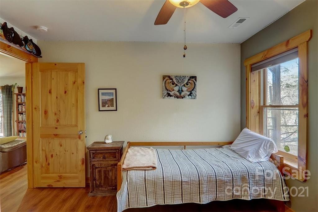 263 Summer Circle Clyde, NC 28721 - Photo 21 of 36 a bedroom with a bed and wooden floor