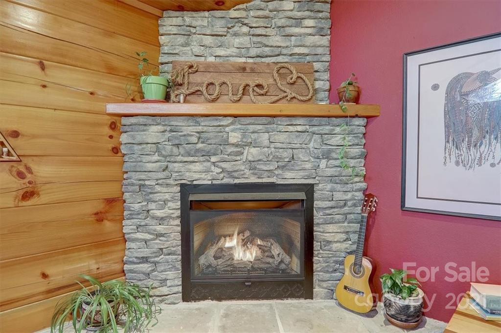 263 Summer Circle Clyde, NC 28721 - Photo 7 of 36 a fireplace with a clock on top of it
