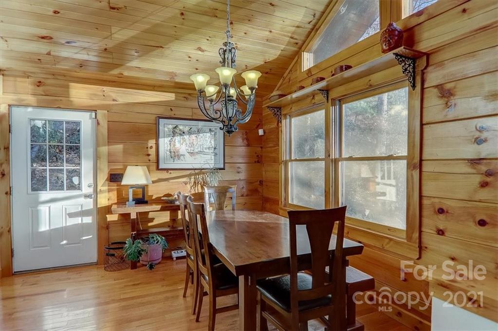 263 Summer Circle Clyde, NC 28721 - Photo 8 of 36 a view of a dining room with furniture and wooden floor