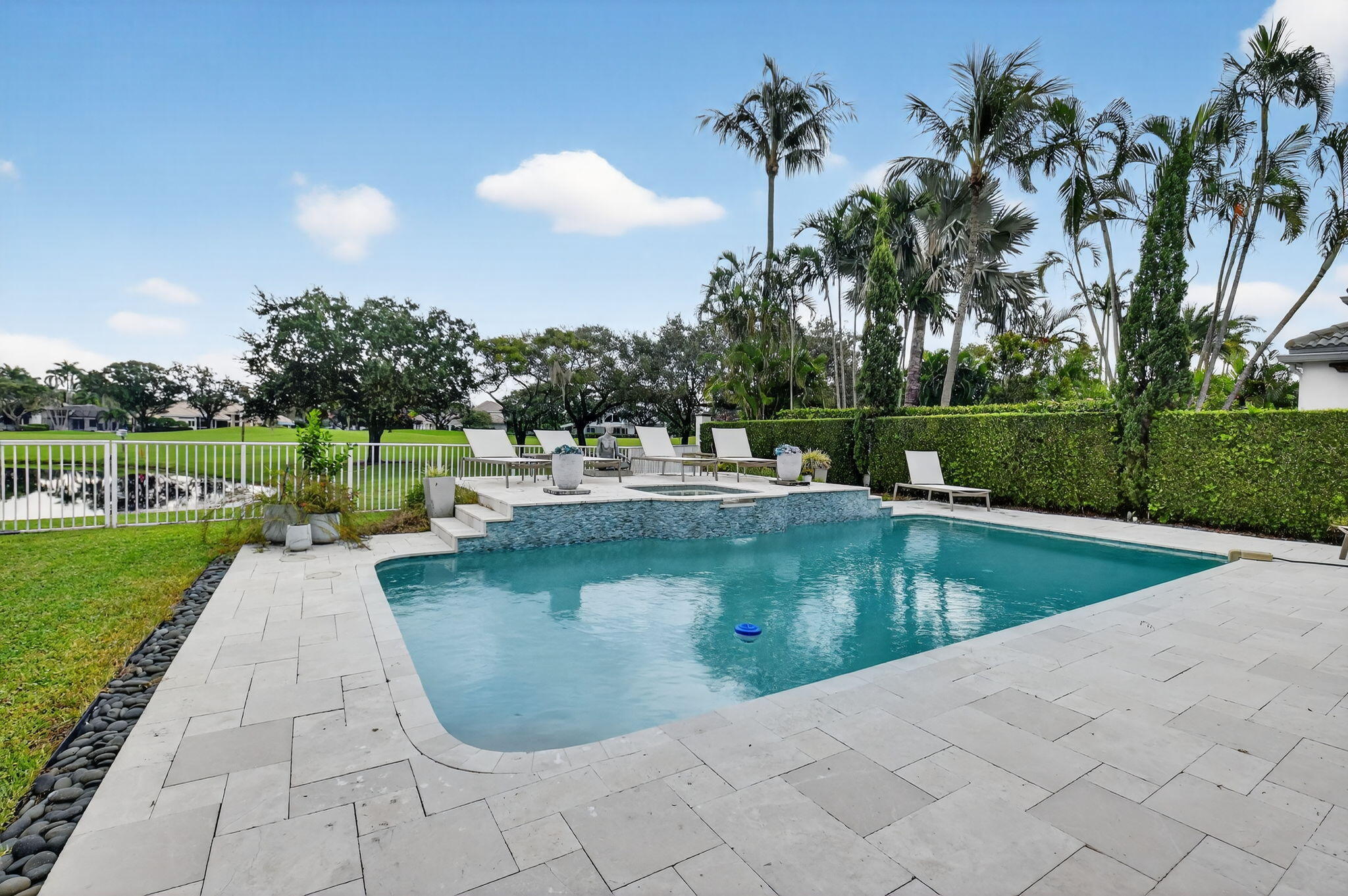 2563 Northwest 63rd Street Boca Raton, FL 33496 - Photo 48 of 65 a view of a swimming pool with a patio