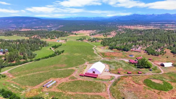 an aerial view of a house with a yard