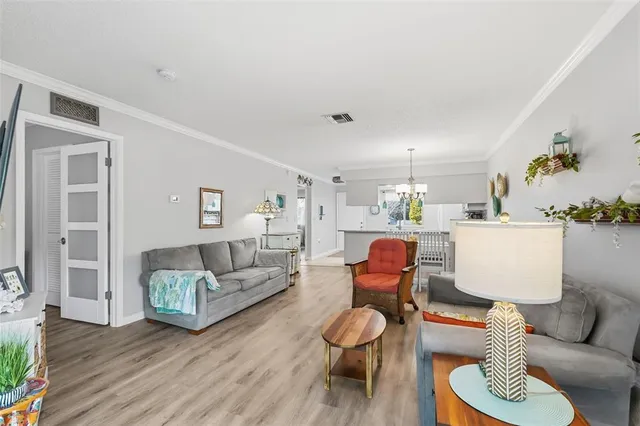 a bedroom with a bed chandelier and a window