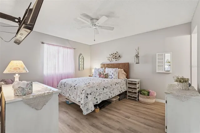 a bedroom with a large bed and a flat screen tv