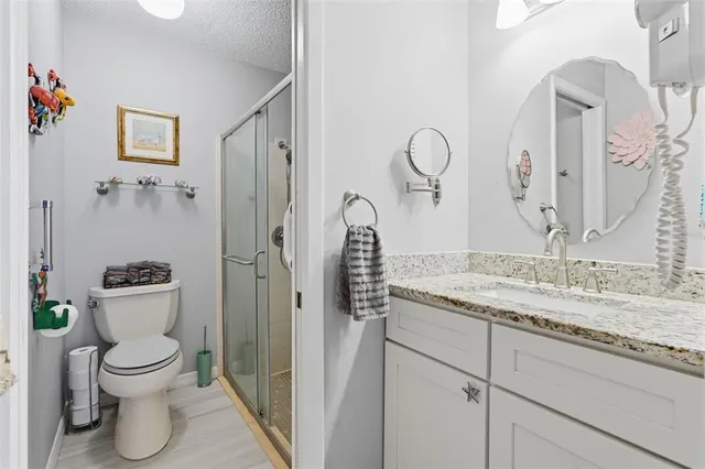 a bathroom with a toilet a sink and shower
