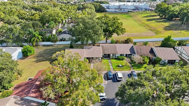 an aerial view of a house with a yard and fountain
