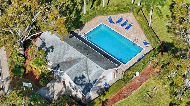 a front view of a house with a yard and potted plants