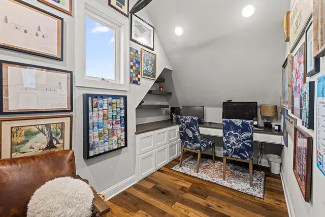 a kitchen with stainless steel appliances granite countertop a kitchen island a stove a table and chairs