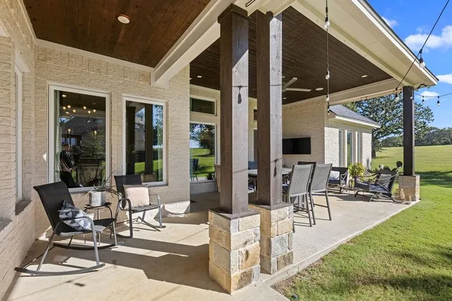 a view of a patio with table and chairs and potted plants