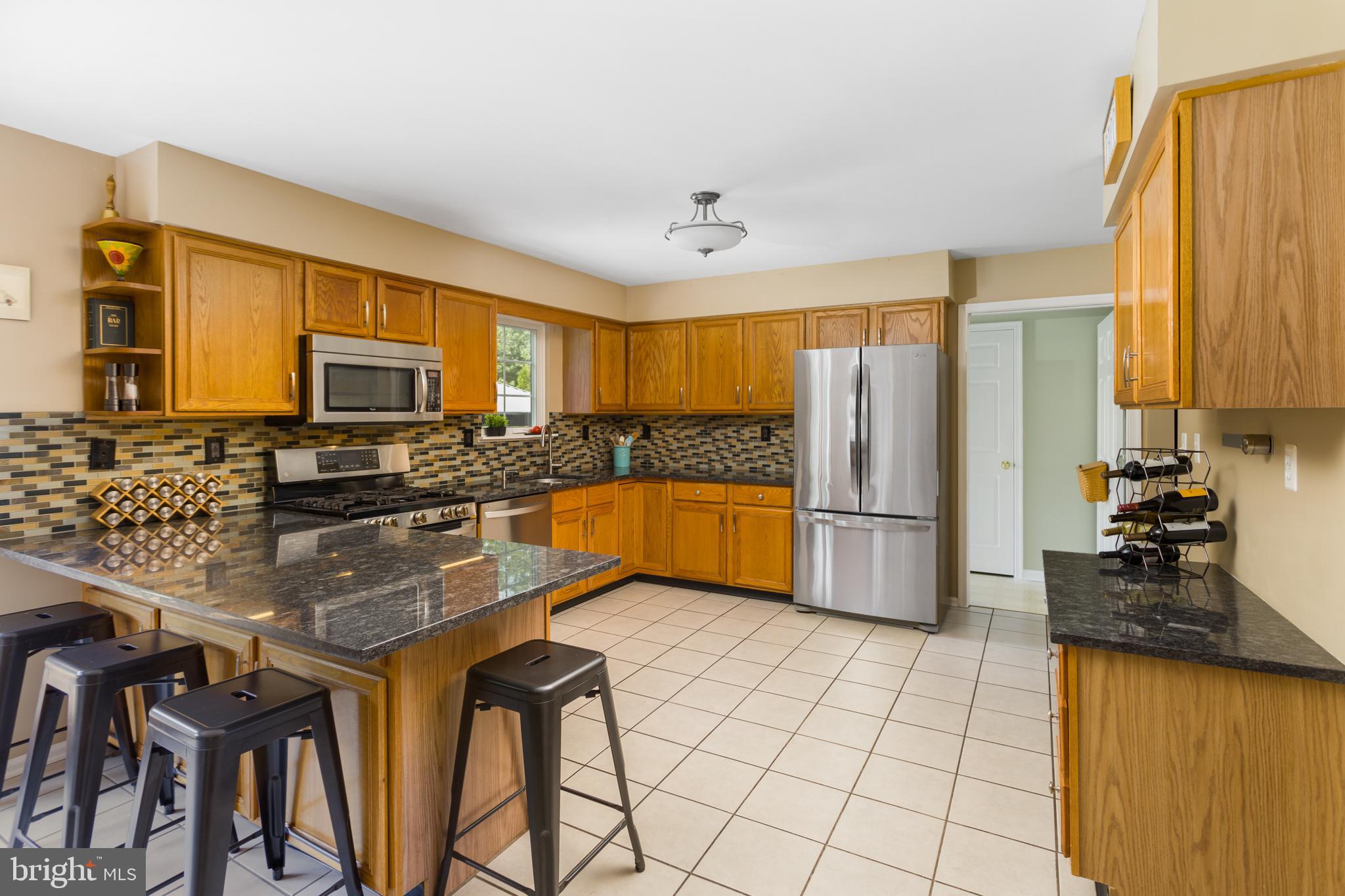 34 Valley Forge Road Bordentown, NJ 08505 - Photo 13 of 56 a kitchen with stainless steel appliances granite countertop a stove a sink a microwave and a refrigerator