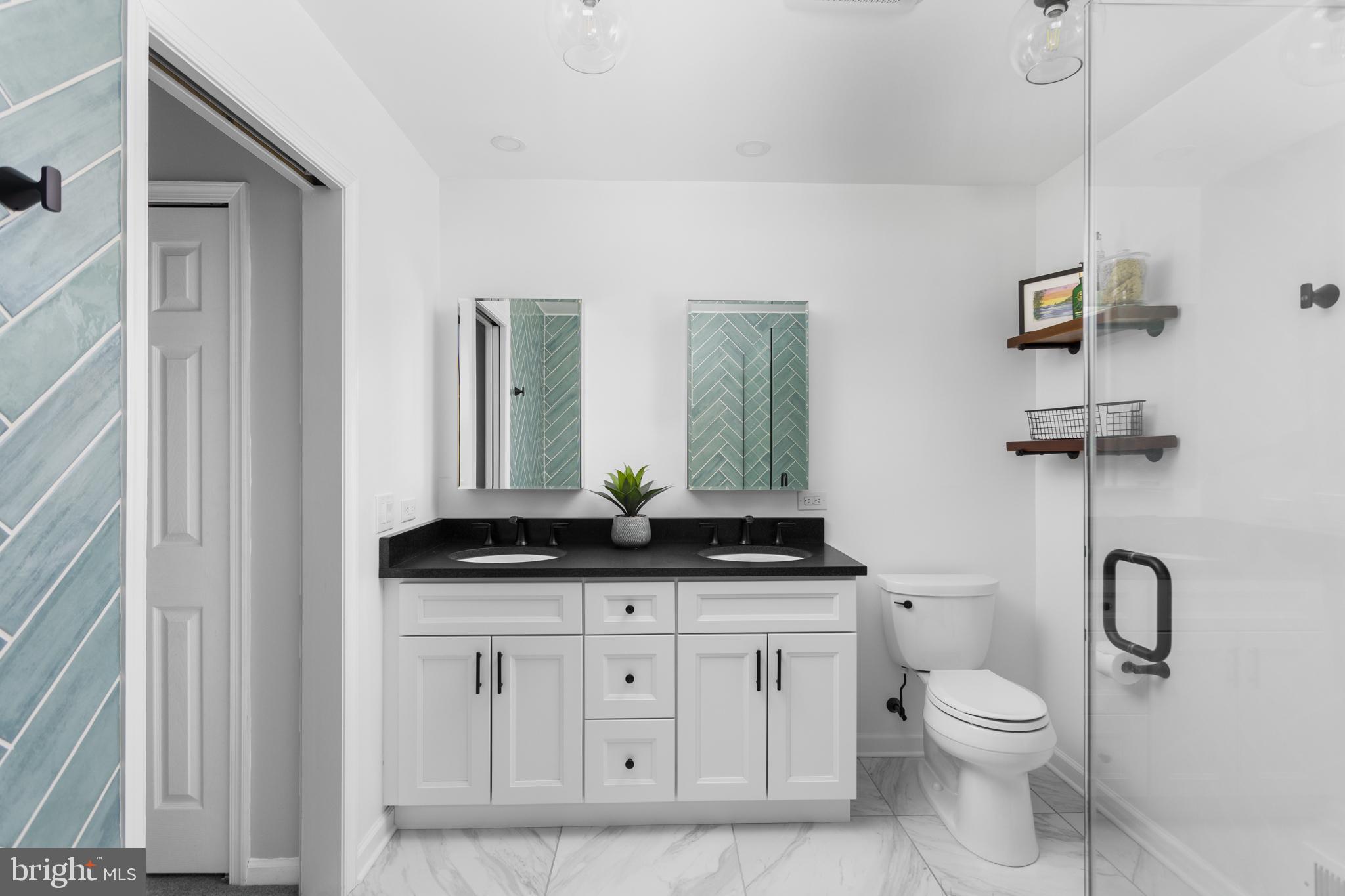 34 Valley Forge Road Bordentown, NJ 08505 - Photo 27 of 56 a bathroom with a granite countertop toilet a sink and a mirror