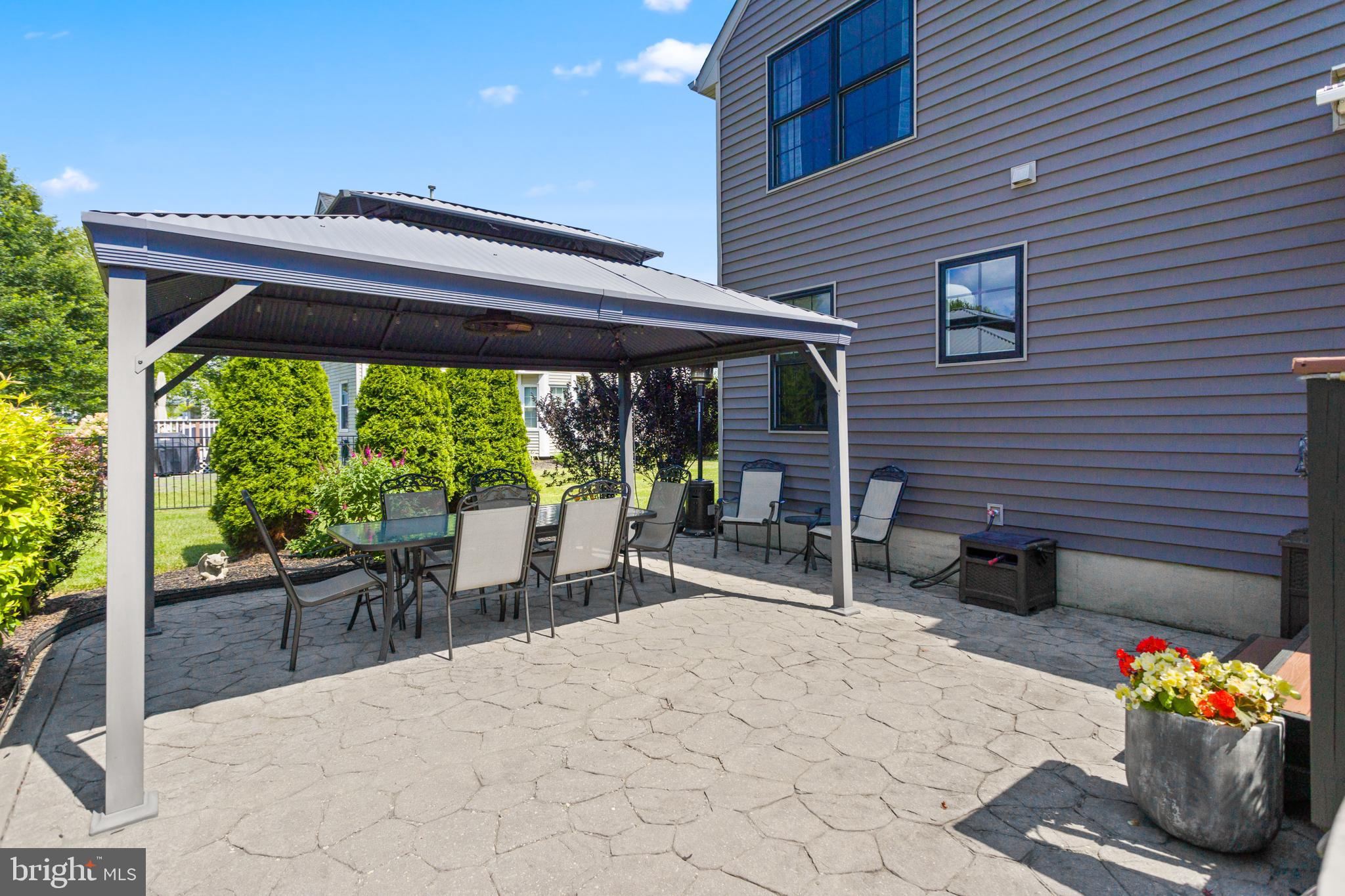 34 Valley Forge Road Bordentown, NJ 08505 - Photo 46 of 56 a view of a patio with a dining table and chairs under an umbrella