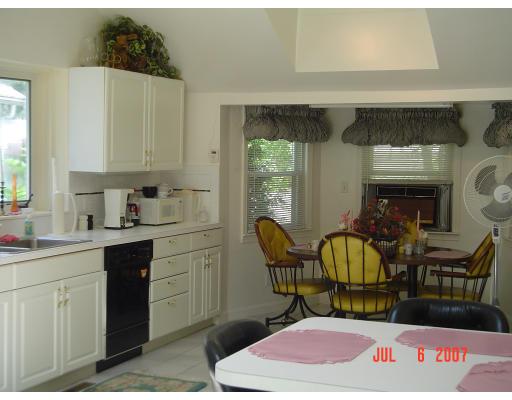 153 Swifts Beach Road Wareham, MA 02571 - Photo 4 of 9 a kitchen with a sink a table and chairs in it