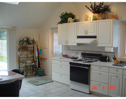153 Swifts Beach Road Wareham, MA 02571 - Photo 5 of 9 a kitchen with a stove and a refrigerator