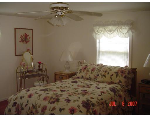 153 Swifts Beach Road Wareham, MA 02571 - Photo 8 of 9 a bedroom with a bed and a table