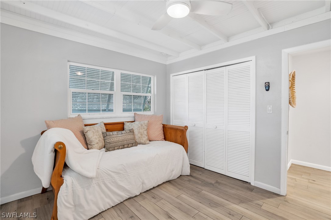 18639 Evergreen Road Fort Myers, FL 33967 - Photo 18 of 33 a bedroom with bed and wooden floor