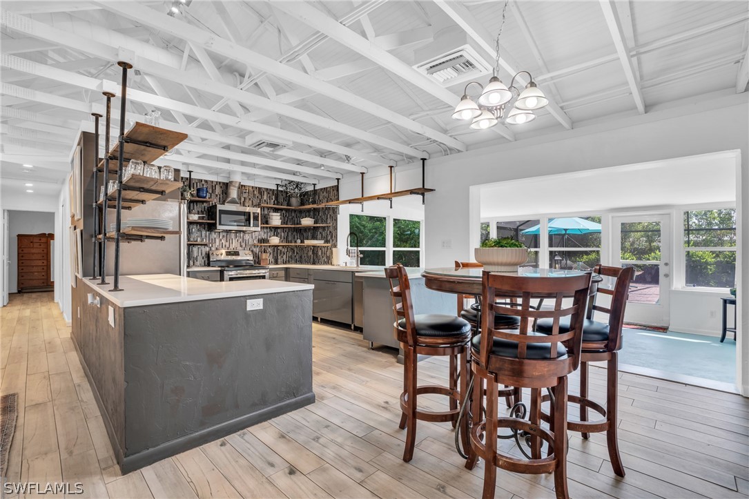 18639 Evergreen Road Fort Myers, FL 33967 - Photo 8 of 33 a view of a dining room with furniture window and wooden floor