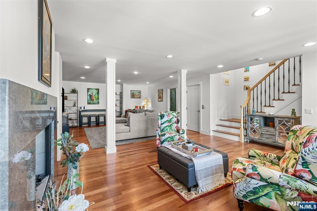 7 Oakdene Terrace, Unit 7 Edgewater, NJ 07020 - Photo 6 of 30 a living room with fireplace furniture and a kitchen view