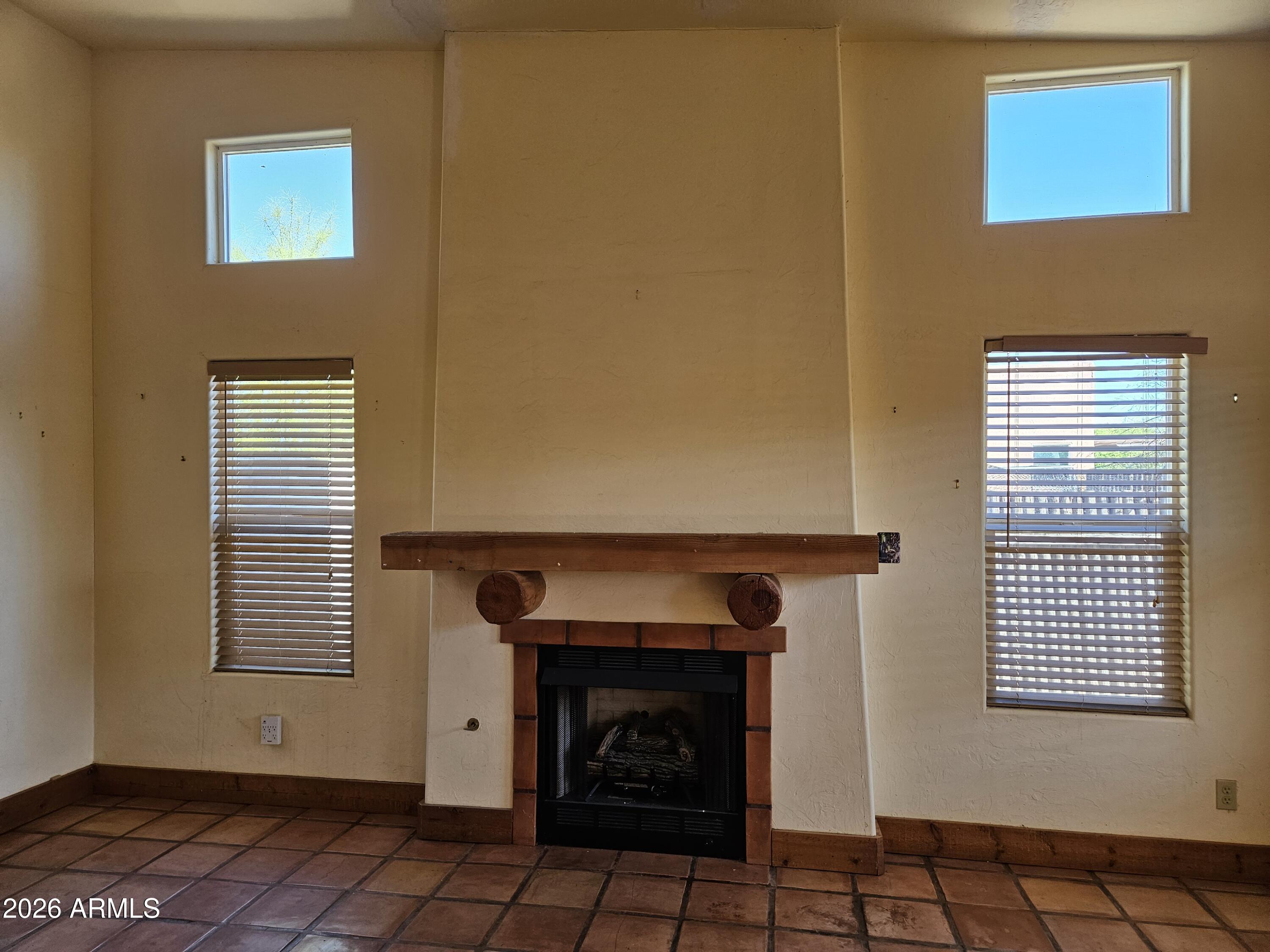 4105 North Washington Avenue Douglas, AZ 85607 - Photo 7 of 61 a view of an empty room with a fireplace and a window