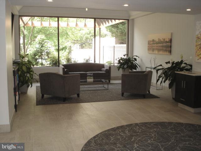 1301 North Courthouse Road, Unit 1109 Arlington, VA 22201 - Photo 3 of 20 a living room with furniture and a large window