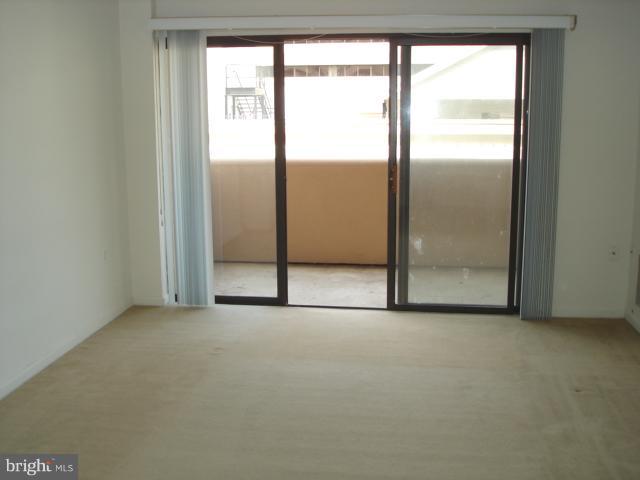 1301 North Courthouse Road, Unit 1109 Arlington, VA 22201 - Photo 4 of 20 an empty room with windows and closet