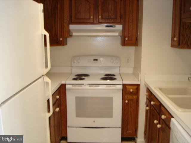 1301 North Courthouse Road, Unit 1109 Arlington, VA 22201 - Photo 10 of 20 a stove top oven sitting inside of a kitchen
